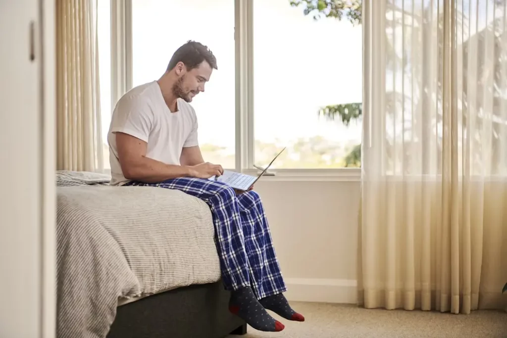 man-with-laptop A man at home efficiently uses a self-service knowledge base to troubleshoot issues